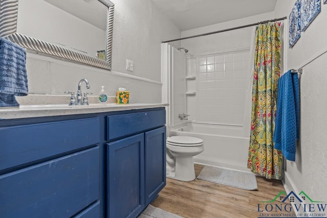 718 Pine St, Gilmer, TX 75644 - full bathroom with toilet, wood finished floors, vanity, and a textured wall