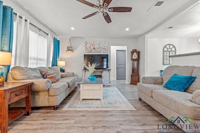718 Pine St, Gilmer, TX 75644 - living area with wood finished floors, ceiling fan, and recessed lighting