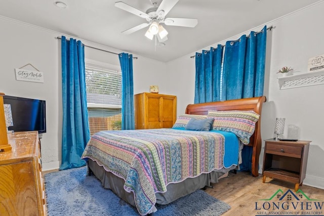 718 Pine St, Gilmer, TX 75644 - bedroom featuring a ceiling fan, ornamental molding, baseboards, and wood finished floors