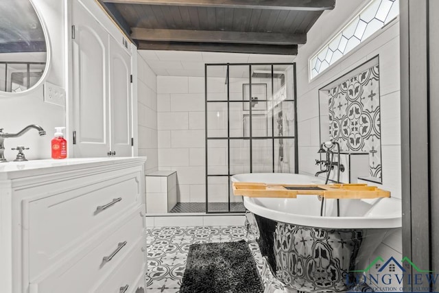 718 Pine St, Gilmer, TX 75644 - bathroom featuring beam ceiling, vanity, tile patterned flooring, a shower stall, and a freestanding tub