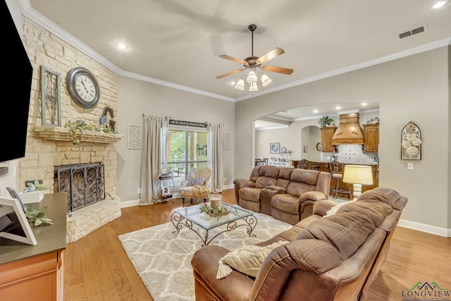 220 Cedar Rdg, Longview, TX 75602 - living room with crown molding, arched walkways, a ceiling fan, and light wood finished floors