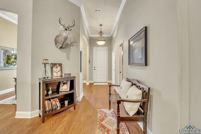 220 Cedar Rdg, Longview, TX 75602 - hallway with crown molding, visible vents, baseboards, arched walkways, and light wood-style flooring