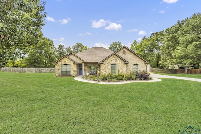 220 Cedar Rdg, Longview, TX 75602 - french country style house with fence, a shingled roof, stone siding, and a front yard