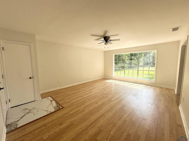 3401 Cooper Ln, Texarkana, TX 75503 - spare room featuring a ceiling fan, baseboards, and light wood finished floors