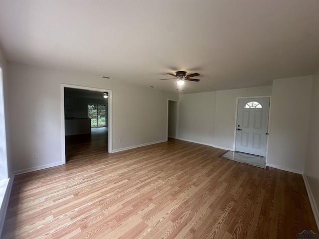 3401 Cooper Ln, Texarkana, TX 75503 - unfurnished living room with a ceiling fan, light wood-type flooring, and baseboards