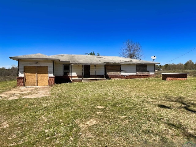 ranch-style house featuring an attached garage and a front lawn