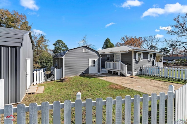 view of front of property with a front yard and a storage shed