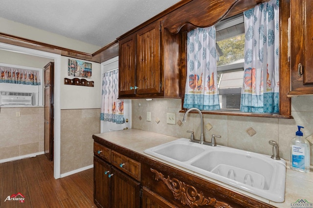 kitchen featuring a textured ceiling, cooling unit, dark wood-type flooring, and sink