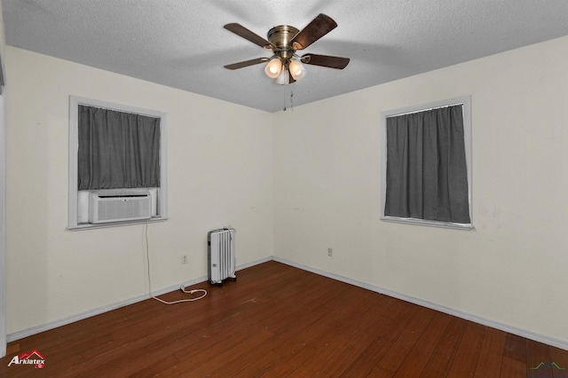 empty room with radiator heating unit, a textured ceiling, dark hardwood / wood-style floors, and ceiling fan