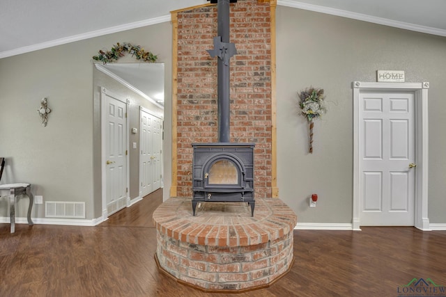 living room with a wood stove, dark hardwood / wood-style flooring, and ornamental molding