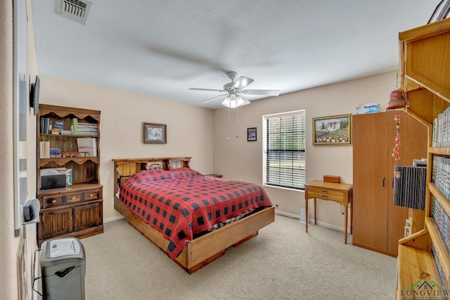 bedroom with light colored carpet and ceiling fan