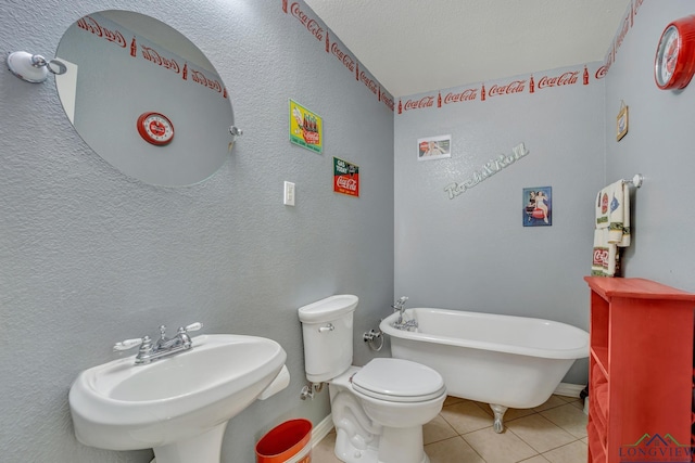 bathroom with sink, tile patterned flooring, a bath, and toilet