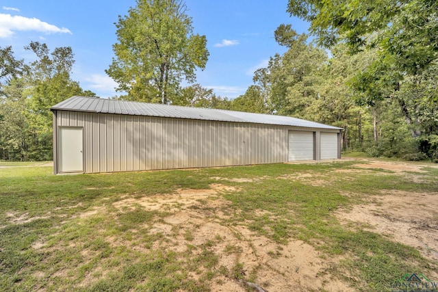 view of outbuilding with a yard