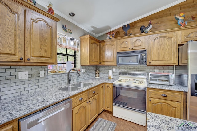 kitchen featuring tasteful backsplash, sink, pendant lighting, and appliances with stainless steel finishes