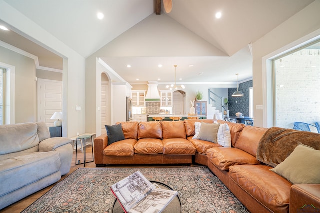 living room with vaulted ceiling with beams, a healthy amount of sunlight, and ornamental molding