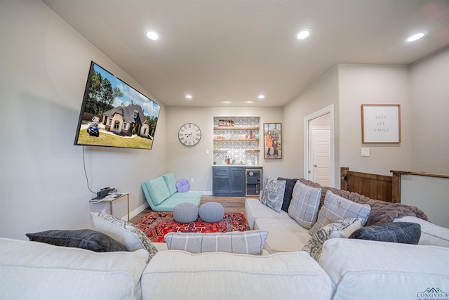 living room featuring built in features, beverage cooler, and bar area