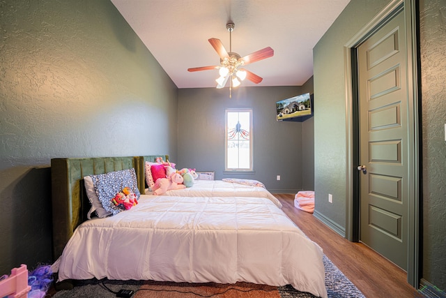 bedroom featuring hardwood / wood-style flooring and ceiling fan