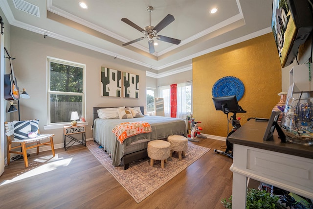 bedroom featuring ornamental molding, a raised ceiling, ceiling fan, and dark wood-type flooring