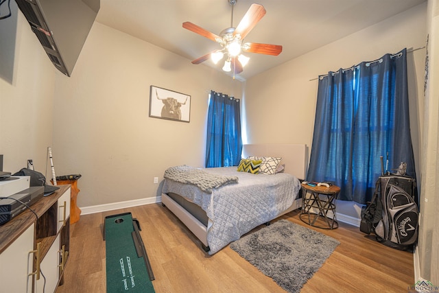 bedroom with hardwood / wood-style floors and ceiling fan