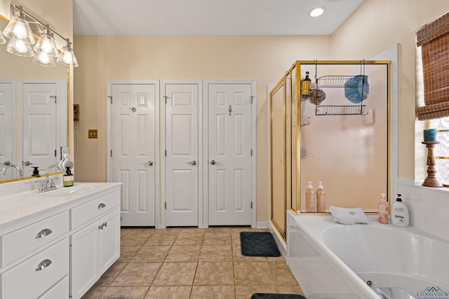 bathroom featuring vanity, tile patterned floors, and plus walk in shower