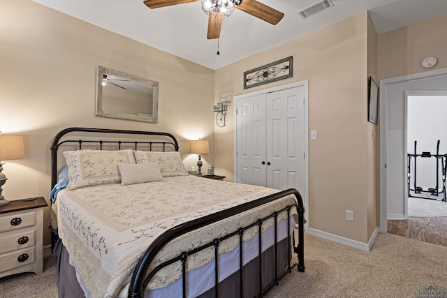 bedroom with a closet, ceiling fan, and light colored carpet