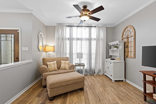 sitting room with ceiling fan, ornamental molding, and light hardwood / wood-style floors