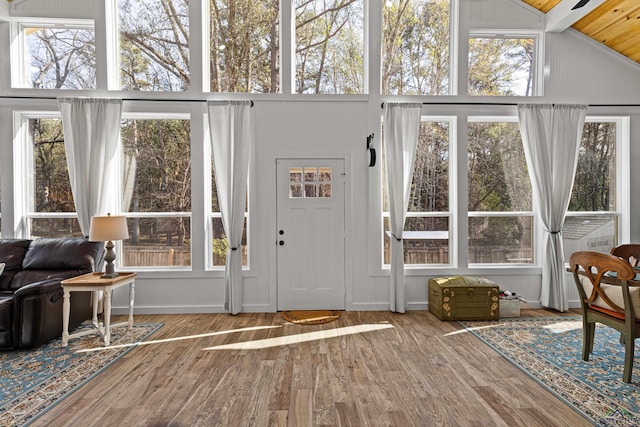 sunroom / solarium featuring wooden ceiling and lofted ceiling