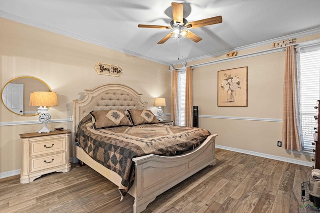 bedroom with ceiling fan, crown molding, and dark hardwood / wood-style floors