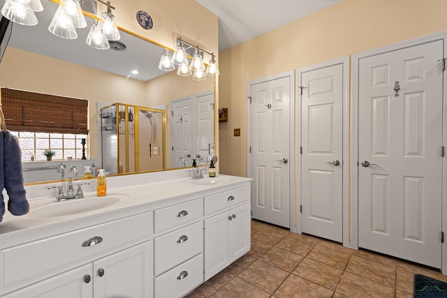 bathroom featuring vanity, tile patterned floors, and a shower with shower door