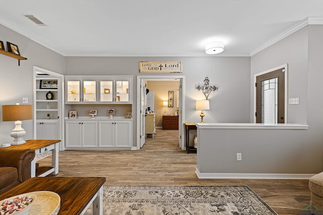 living room with ornamental molding and light wood-type flooring