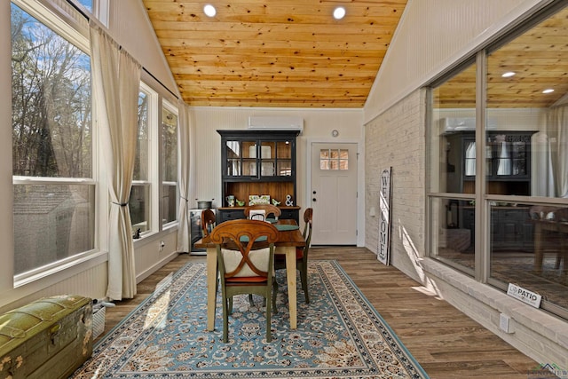 sunroom with an AC wall unit, vaulted ceiling, and wood ceiling