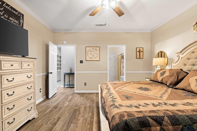 bedroom featuring hardwood / wood-style flooring, ceiling fan, and ornamental molding