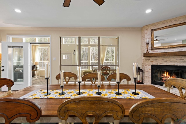 sitting room with ornamental molding, ceiling fan, a fireplace, and wood-type flooring