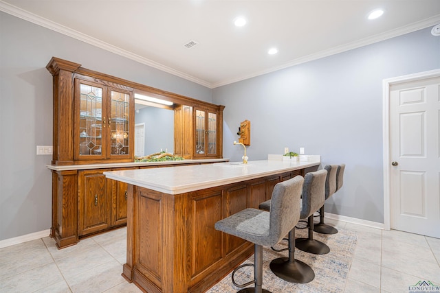 bar with sink, light tile patterned floors, and ornamental molding