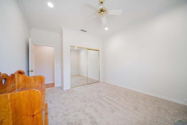 bedroom with ceiling fan, a closet, light carpet, and ornamental molding