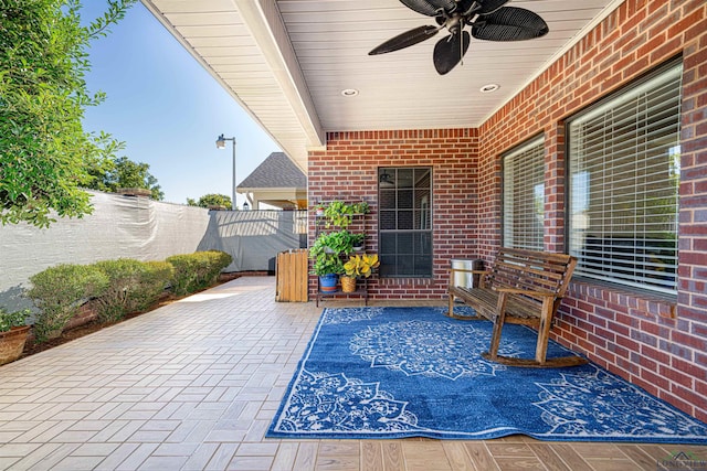 view of patio featuring ceiling fan