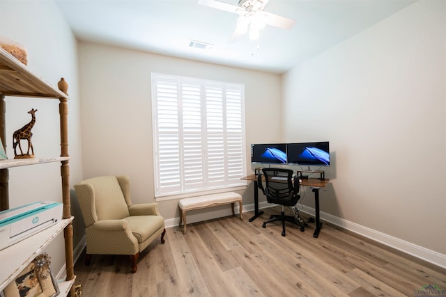 office area with ceiling fan, light wood-type flooring, visible vents, and baseboards