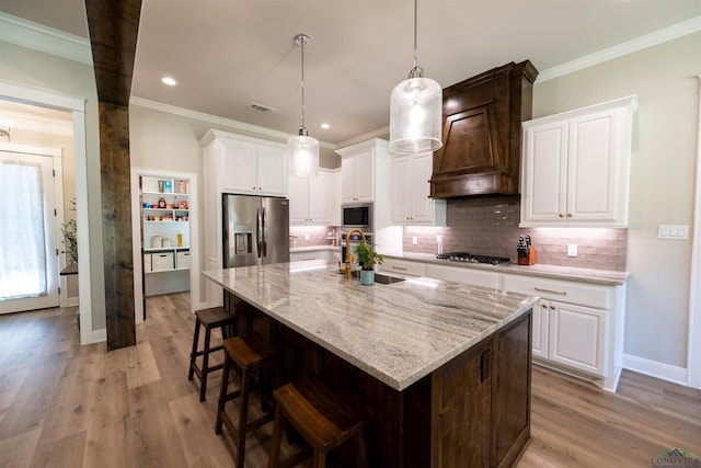 kitchen with premium range hood, appliances with stainless steel finishes, backsplash, and ornamental molding