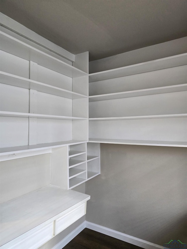 2013 E Warwick Cir, Longview, TX 75601 - walk in closet with dark wood-style flooring