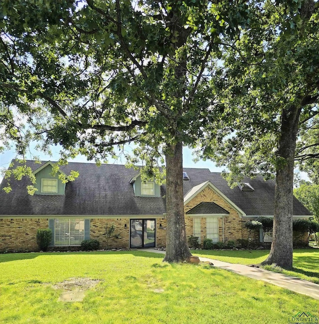 2013 E Warwick Cir, Longview, TX 75601 - view of front facade with brick siding and a front lawn