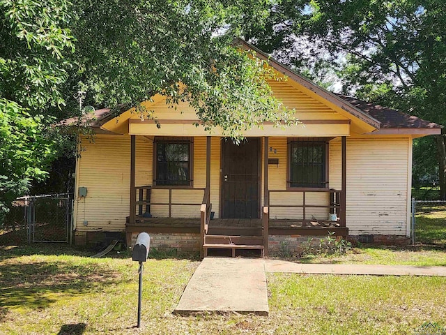 bungalow featuring a front yard and a porch