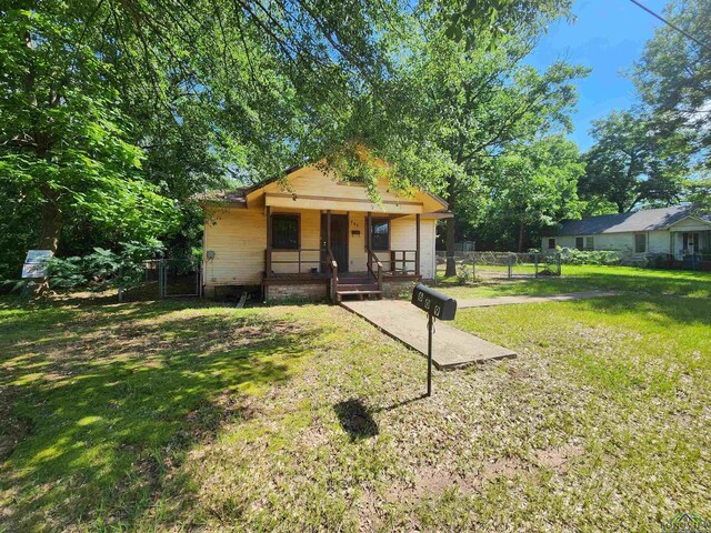 bungalow-style house with a front lawn and a porch