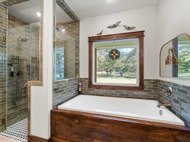 bathroom with separate shower and tub