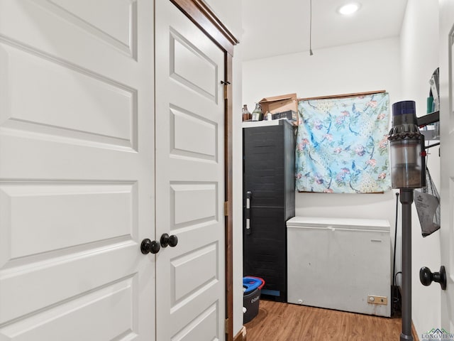 laundry area featuring light wood-type flooring