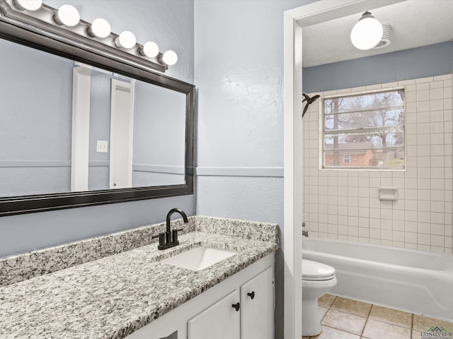 full bathroom featuring tile patterned flooring, shower / washtub combination, toilet, and vanity