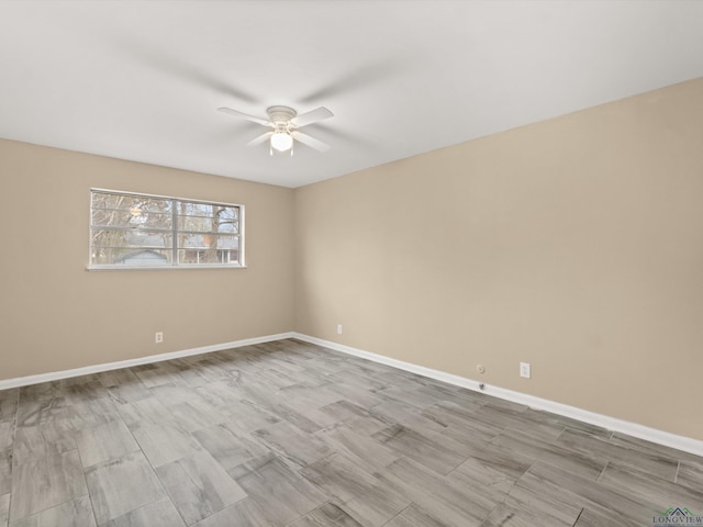 unfurnished room featuring baseboards, ceiling fan, and wood finished floors