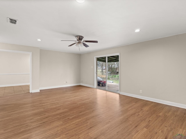 unfurnished room featuring visible vents, ceiling fan, baseboards, and light wood-style floors