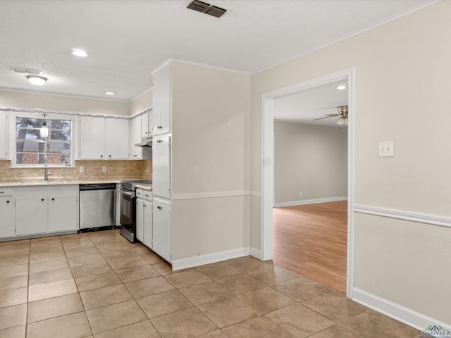 kitchen with visible vents, light countertops, light tile patterned flooring, white cabinets, and stainless steel appliances