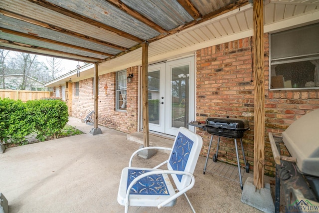 view of patio featuring french doors, fence, and grilling area