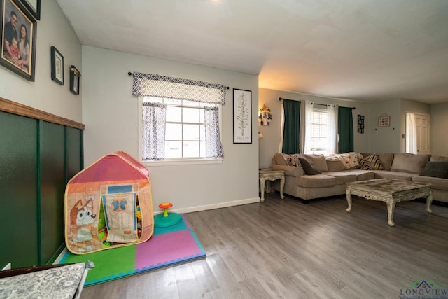 playroom featuring baseboards and wood finished floors